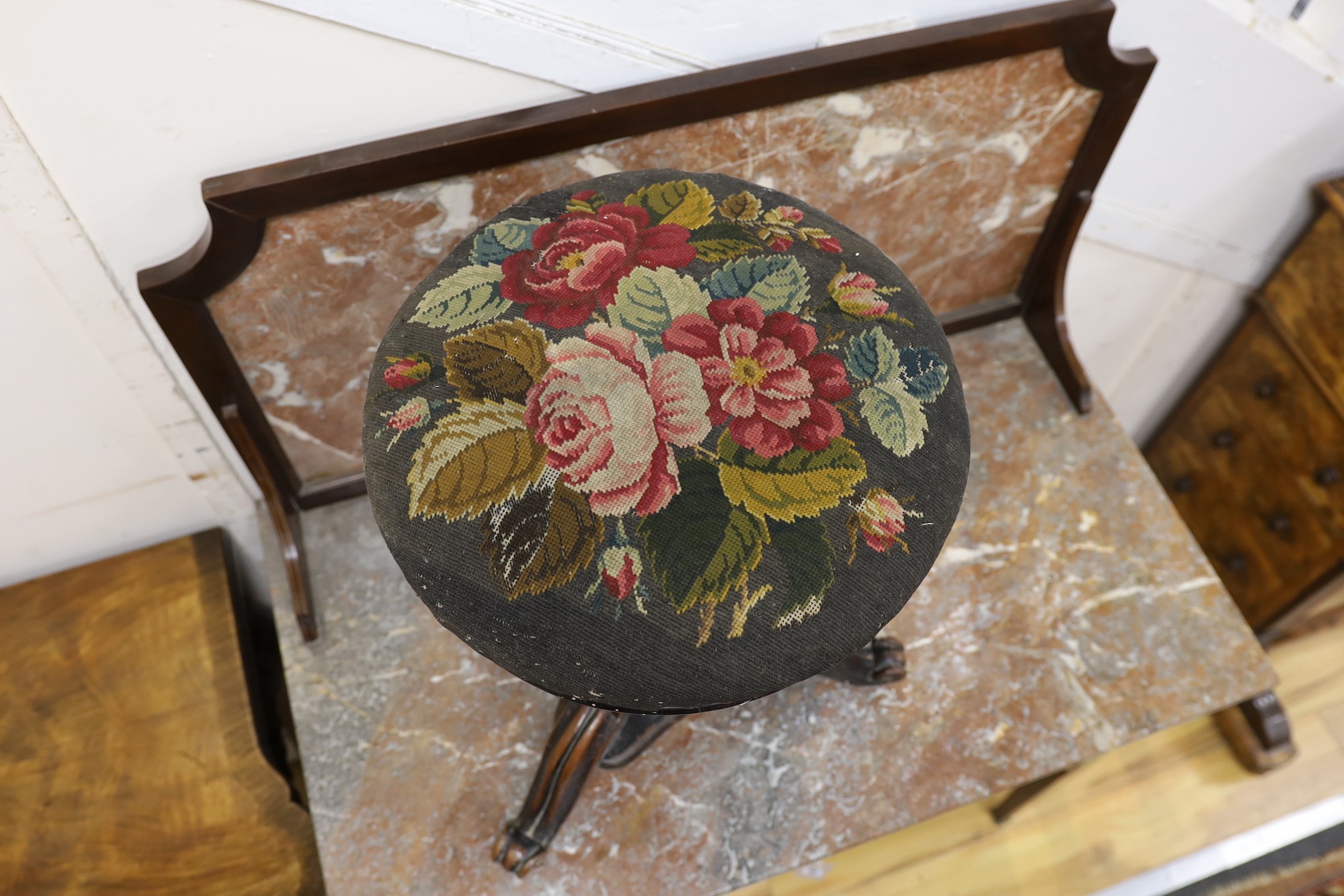 A Victorian mahogany adjustable revolving piano stool with tapestry seat